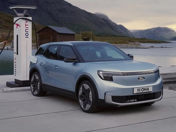 Woman with car at public station EV charging